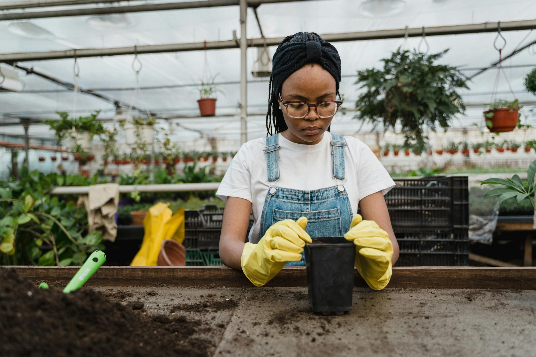 woman in white shirt preparing a pot for planting